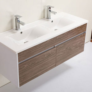 Jack & Jill style bathroom vanity with light colored wood and chrome faucets